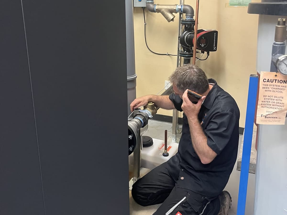 Technicians servicing a commercial boiler